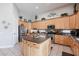 Spacious kitchen with light wood cabinets, stainless appliances, and a large center island at 3053 S Canfield --, Mesa, AZ 85212