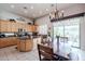 Eat-in kitchen with tile floors, an island, wood cabinets, and modern appliances at 3053 S Canfield --, Mesa, AZ 85212