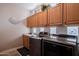 Laundry room with front load washer/dryer and upper cabinets at 3053 S Canfield --, Mesa, AZ 85212