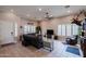 Bright and airy living room featuring tile flooring, plantation shutters, and a cozy seating area at 3053 S Canfield --, Mesa, AZ 85212