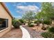 Backyard walkway with desert landscaping and cacti leading to the house at 3700 N 149Th Ln, Goodyear, AZ 85395