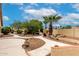 Backyard features landscaped garden with winding walkways and mature desert trees at 3700 N 149Th Ln, Goodyear, AZ 85395