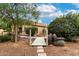 Landscaped backyard featuring a small bridge with rope railings with native cactus and desert landscaping at 3700 N 149Th Ln, Goodyear, AZ 85395