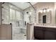Modern bathroom featuring a glass-enclosed shower with marble tiling, a built-in seat, and updated vanity at 3700 N 149Th Ln, Goodyear, AZ 85395