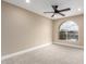 Bright bedroom featuring neutral carpet, recessed lighting, and an arched window overlooking the neighborhood at 3700 N 149Th Ln, Goodyear, AZ 85395