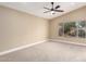 Spacious bedroom featuring neutral carpet and a window overlooking a tranquil outdoor view at 3700 N 149Th Ln, Goodyear, AZ 85395