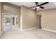Large bedroom featuring neutral carpet, a ceiling fan, and sliding glass doors leading to an outdoor patio at 3700 N 149Th Ln, Goodyear, AZ 85395