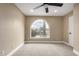 Inviting bedroom featuring neutral carpet, an arched window with neighborhood views, and a closet at 3700 N 149Th Ln, Goodyear, AZ 85395
