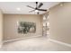Well-lit bedroom with a ceiling fan, neutral carpet, and access to the backyard through sliding glass doors at 3700 N 149Th Ln, Goodyear, AZ 85395
