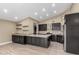 Kitchen with gray cabinets, quartz countertops, and stainless steel appliances at 3700 N 149Th Ln, Goodyear, AZ 85395