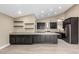 Kitchen with gray cabinets, quartz countertops, stainless steel appliances, and wood floors at 3700 N 149Th Ln, Goodyear, AZ 85395