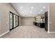 Bright, open-concept living room with tile floors, sliding glass doors, and a built-in bar at 3700 N 149Th Ln, Goodyear, AZ 85395