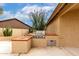 Outdoor kitchen with built-in grill and barbecue in desert landscaped backyard at 3700 N 149Th Ln, Goodyear, AZ 85395