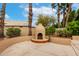 Inviting backyard with stucco outdoor fireplace and desert landscaping at 3700 N 149Th Ln, Goodyear, AZ 85395
