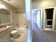 Bright bathroom with vanity, toilet, bathtub, and a glimpse into the hallway with a laundry area at 3930 W Monterey St # 115, Chandler, AZ 85226