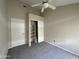Bedroom featuring neutral carpeting, closet, and ceiling fan for added comfort at 3930 W Monterey St # 115, Chandler, AZ 85226