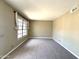 Neutral bedroom with a large window providing natural light, and neutral carpet at 3930 W Monterey St # 115, Chandler, AZ 85226