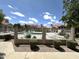 Fenced community pool with lounge chairs surrounded by lush landscaping and well-maintained grounds at 3930 W Monterey St # 115, Chandler, AZ 85226