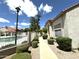 Attractive exterior view with walkway to the building, beautiful landscaping, and community pool at 3930 W Monterey St # 115, Chandler, AZ 85226