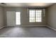 Bright living room featuring neutral walls, plush carpeting, and a large window with natural light at 3930 W Monterey St # 115, Chandler, AZ 85226