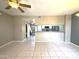 Open-concept living area with neutral color palette, tile flooring, and partial view of the kitchen at 3930 W Monterey St # 115, Chandler, AZ 85226