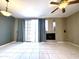 Living room with a ceiling fan, tile flooring, fireplace, and sliding glass doors to the outside at 3930 W Monterey St # 115, Chandler, AZ 85226