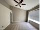Spacious main bedroom with neutral carpet, large window and ceiling fan at 3930 W Monterey St # 115, Chandler, AZ 85226