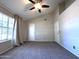 Main bedroom featuring a large window with blinds, neutral carpeting, and ensuite access at 3930 W Monterey St # 115, Chandler, AZ 85226