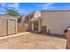 View of the home's private backyard with a wooden fence and stucco walls, offering a secure and secluded outdoor space at 4836 W Rose Ln, Glendale, AZ 85301