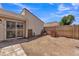 Backyard featuring a wood fence and sliding door and some building materials at 4836 W Rose Ln, Glendale, AZ 85301