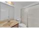 Bright bathroom featuring a shower, toilet, and sink with tan counter and vanity at 4836 W Rose Ln, Glendale, AZ 85301
