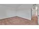 Neutral bedroom featuring plush carpet and entry door with hallway access at 4836 W Rose Ln, Glendale, AZ 85301