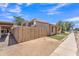 Exterior view of a single story townhome with desert landscaping and a wooden fence at 4836 W Rose Ln, Glendale, AZ 85301