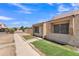 Exterior view showing the front of the home and sidewalk, with desert landscaping at 4836 W Rose Ln, Glendale, AZ 85301
