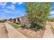 Exterior view of the side of the home showing the sidewalk and desert landscaping at 4836 W Rose Ln, Glendale, AZ 85301