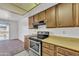Eat-in kitchen showcasing stainless steel range and complementing wood cabinets at 4836 W Rose Ln, Glendale, AZ 85301