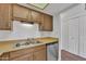 Traditional kitchen featuring wood cabinets, stainless steel dishwasher, and sink at 4836 W Rose Ln, Glendale, AZ 85301