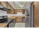 Traditional kitchen featuring stainless steel refrigerator, wood cabinets, and updated appliances at 4836 W Rose Ln, Glendale, AZ 85301
