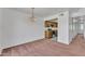 Open layout of living room and kitchen, featuring neutral paint and carpet at 4836 W Rose Ln, Glendale, AZ 85301