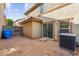View of a private backyard featuring a sliding glass door and air conditioning unit at 523 N Ranger Trl, Gilbert, AZ 85234
