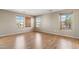 Sunny bedroom with three windows and wood laminate flooring at 523 N Ranger Trl, Gilbert, AZ 85234