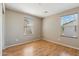 Cozy bedroom with wood laminate flooring and two windows for natural light at 523 N Ranger Trl, Gilbert, AZ 85234