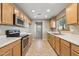 Well-lit kitchen featuring stainless steel appliances, and bright, neutral countertops at 523 N Ranger Trl, Gilbert, AZ 85234
