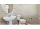 A half bathroom with a pedestal sink and neutral wall paint at 523 N Ranger Trl, Gilbert, AZ 85234