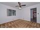This is a well-lit bedroom features a ceiling fan and a window for natural light at 6041 E Colby St, Mesa, AZ 85205