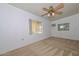 Bedroom featuring carpet, ceiling fan, and two windows at 6041 E Colby St, Mesa, AZ 85205