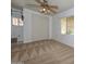 Bedroom features carpet, a ceiling fan, and a double closet for storage at 6041 E Colby St, Mesa, AZ 85205