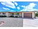 Ranch-style house features a two-car garage, desert landscaping, and neutral color palette at 6041 E Colby St, Mesa, AZ 85205