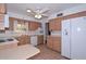 A beautiful kitchen featuring honey oak cabinetry and white appliances at 6041 E Colby St, Mesa, AZ 85205