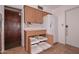 Kitchen featuring pull-out shelving, white refrigerator, and natural wood cabinets at 6041 E Colby St, Mesa, AZ 85205